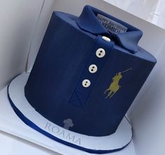 a blue hat that is sitting on top of a box with buttons and a bow