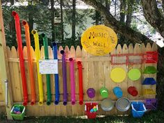 there is a fence that has many different items on it, including plastic cups and spoons