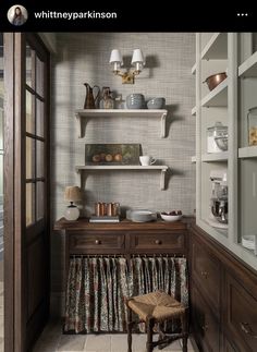 a kitchen with wooden cabinets and shelves filled with dishes