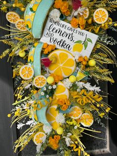 a wreath with lemons and oranges on it