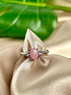 A stunning blend of lab-created Pink Opal and cubic zirconia accents atop a silver-plated brass band. The color combinations reflect light in an exquisite manner. Quick Specs:  +Silver plated Ring band  + Pink Lab Opal  +CZ diamonds  ALL PURCHASES COME GIFT WRAPPED AND W/DISCOUNT CODES! Pink Opal Ring, Valentines Gift For Her, Brass Band, Pink And Silver, Pink Ring, Opal Ring, Cz Diamond, Ring Promise, Pink Opal