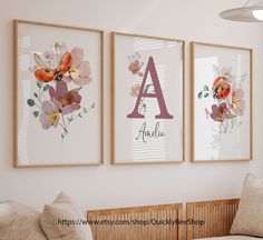 three framed art prints hanging on the wall above a crib in a nursery room