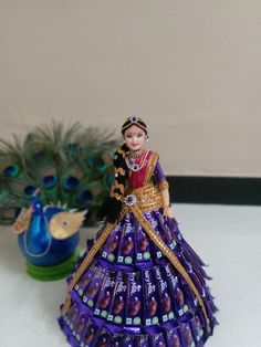 a figurine that is sitting on a table next to a peacock planter