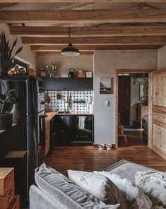 a kitchen with wooden floors and black appliances