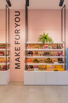 the inside of a store with shelves filled with donuts and other items on display