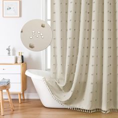 a bath tub sitting next to a window covered in curtains