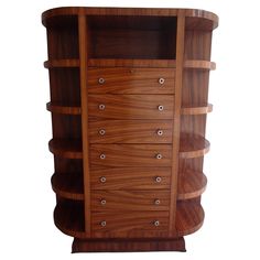 a large wooden cabinet with drawers on the front and bottom shelves in different sizes, shapes and colors