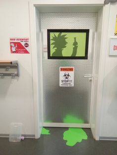 an open door with a green sticker on it