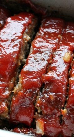 the meatloaf is covered in sauce and ready to be cooked on the grill