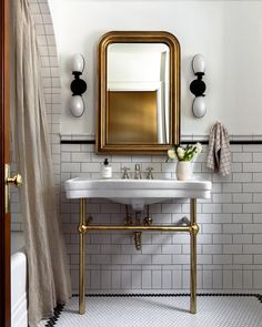 a bathroom with a sink, mirror and towel rack on the wall next to it