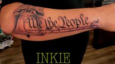 a person with a tattoo on their arm that says we the people inked in