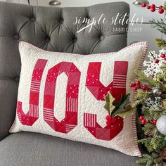 a christmas pillow sitting on top of a couch