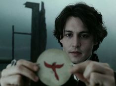 a man holding up a white plate with a red cross on it