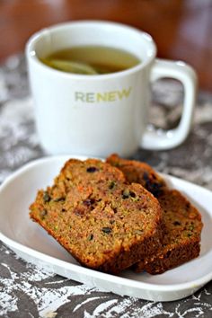 three pieces of bread on a plate next to a cup of tea