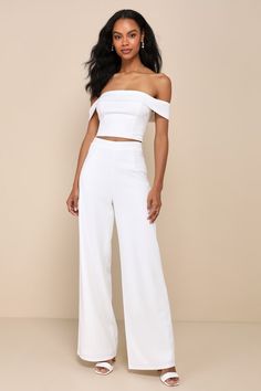 You'll only get more and more fabulous throughout the night while wearing the Lulus Exponentially Chic Ivory Off-the-Shoulder Two-Piece Jumpsuit! Stretchy crepe knit shapes this sensational two-piece jumpsuit that starts with an ultra-cropped top with a princess-seamed bodice and a folded-over, off-the-shoulder neckline (with hidden no-slip strips) that flows into short sleeves. The matching bottoms have a high, banded waist and wide pant legs that finish at full-length hems. An exposed silver z Elegant One-shoulder Party Sets, Fitted One-shoulder Party Sets, Chic Fitted Off-shoulder Set, Elegant Evening Sets For Summer, Elegant Off-shoulder Jumpsuits And Rompers For Party, Elegant Off-shoulder Jumpsuit For Party, Chic Off-shoulder Party Sets, White Strapless Jumpsuit For Evening, Glamorous Strapless Jumpsuit For Summer Formal Events