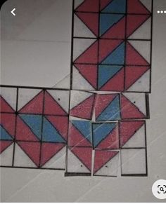 four squares with blue, red and white designs are arranged in the same pattern on top of each other