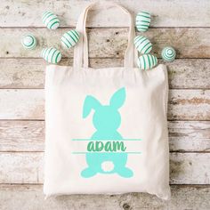 a tote bag with an image of a bunny on it and some candy in the background