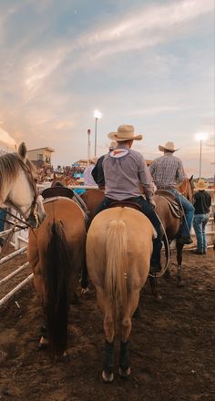 several people riding horses in an arena