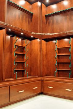 an empty room with wooden shelves and blue brackets on the wall, in which shelving is kept