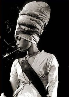 a black and white photo of a woman with a turban on her head