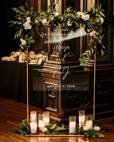 a tall clock with candles and greenery on it