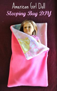 a doll is wrapped in a pink blanket