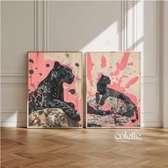 two black and pink paintings on wooden floor next to each other