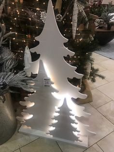 a white christmas tree with lights on it