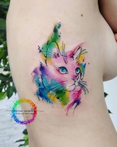 a colorful cat tattoo on the back of a woman's stomach