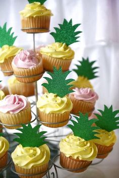 there are cupcakes with pineapple decorations on them