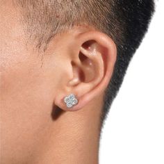 a close up of a person wearing a pair of ear piercings on their ears