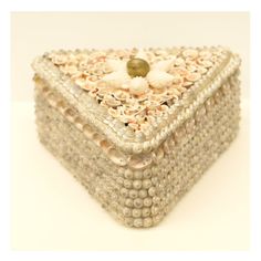 a decorative box with seashells and pearls on it's sides, sitting on a white surface