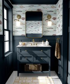 a bathroom with blue walls and gold accents on the vanity, along with a large mirror