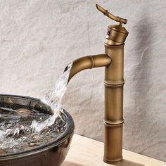 a faucet with water running out of it in a bowl on a counter