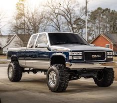 a large blue truck parked on top of a driveway