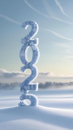 the number two is made out of ice and snow flakes in front of a blue sky