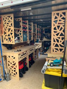 a garage filled with lots of wooden shelves and tools