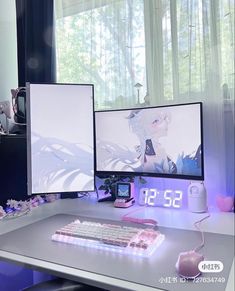 two computer monitors sitting on top of a desk next to a keyboard and monitor screen