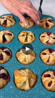 a person cutting into small pastries on a blue plate