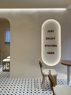 the interior of a restaurant with white walls and black and white tile flooring that says, just enjoy staying here