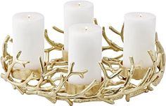 four white candles sitting on top of a metal tray with antlers and branches around it