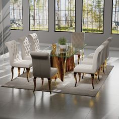 a dining room table with chairs and a rug in front of the glass top table