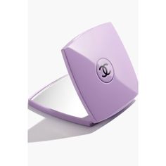 a compact mirror with the letter c on it's front and bottom corner in purple