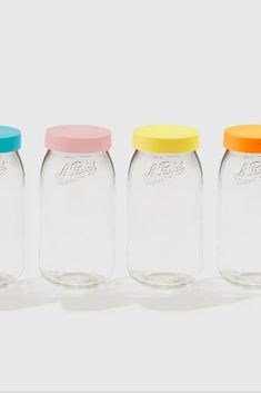 three empty glass jars with colored lids