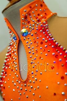 an orange top with lots of sequins on it