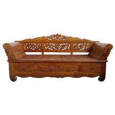 an ornate wooden bench with drawers on the bottom and back ends, sitting against a white background