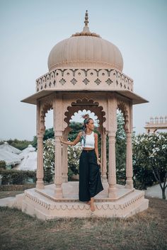 a woman standing in front of a gazebo