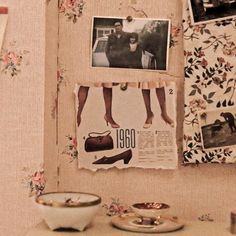 a wall with pictures, photos and other items hanging on it's sideboard