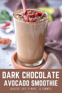 chocolate avocado smoothie in a tall glass with a pink straw on top