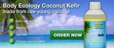 a bottle of coconut kefir is on the beach with palm trees in the background